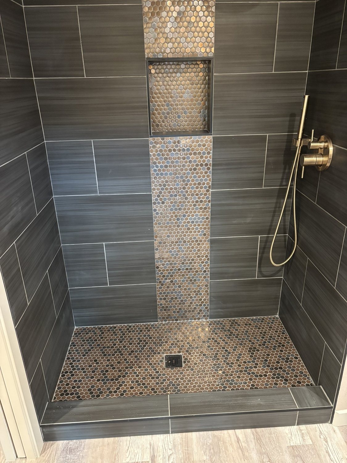 Forest Grove ADU shower featuring tile, a mosaic accent and recessed niche